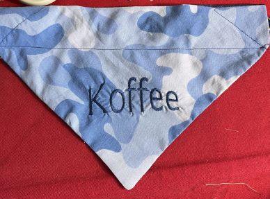 Blue camouflage fabric with the word 'Koffee' embroidered.