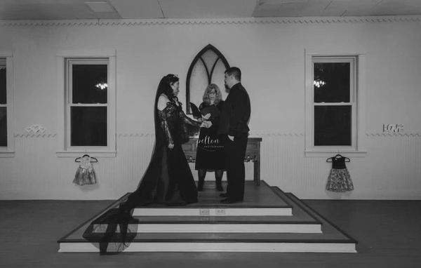 a black and white photo of a couple getting married with our onsite officiator.
