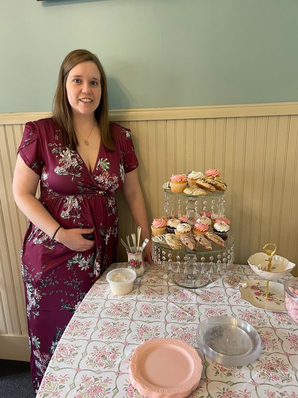 One of our Irvin Manor's girls celebrating her Baby Shower next to some delicious sweet treats.