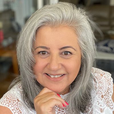 Woman counsellor with grey mid length hair