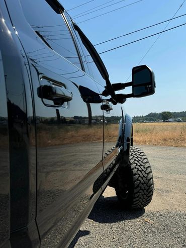 Close-up of ceramic-coated vehicle surface reflecting sunlight