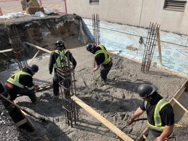 construction crew pouring concrete