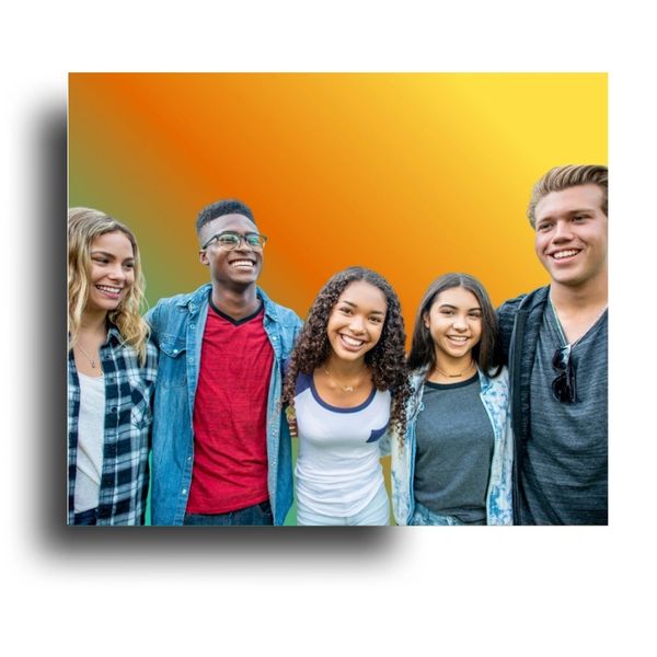 A diverse group of five smiling young adults standing closely together.
