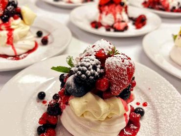 Delicious cream-based desserts topped with strawberries and blueberries for an event in Conwy.