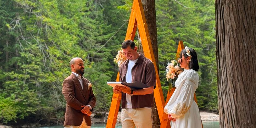 Outdoor wedding ceremony with couple and officiant.