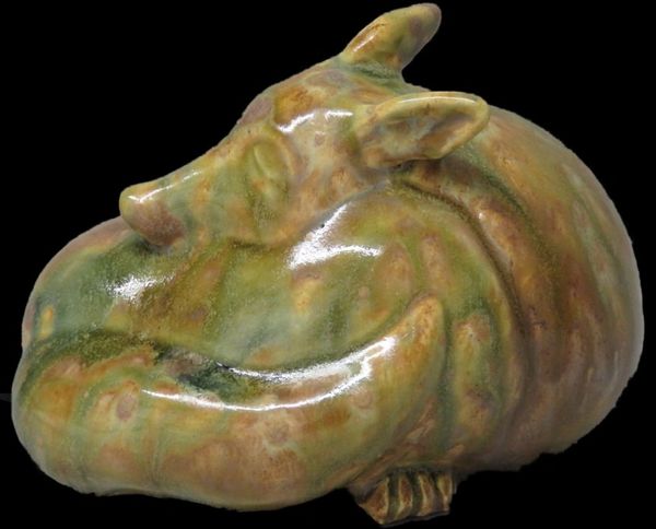 Luis was sculpted in white art clay, fired and finished in a mottled green/brown/tan glaze.  Curled 
