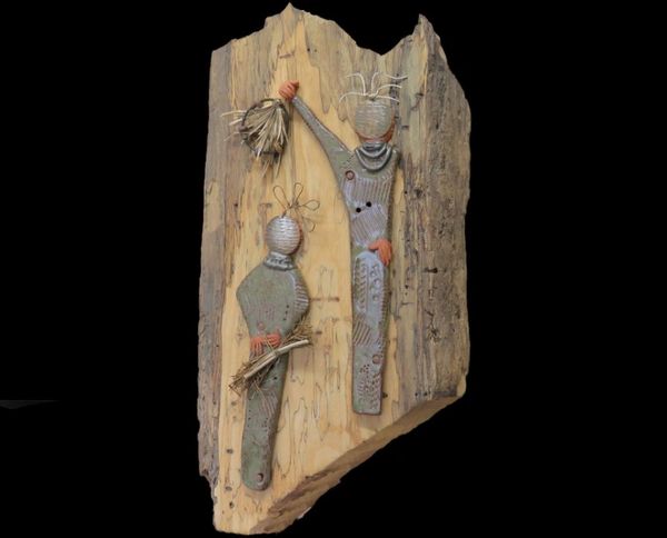 Hunters/Gatherers is a primitive ceramic and mixed media wall hanging  The figures are sculpted in t