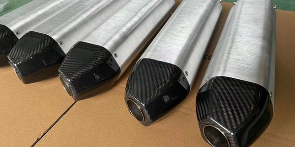 Aluminum motorcycle exhaust pipes with carbon fiber tips.