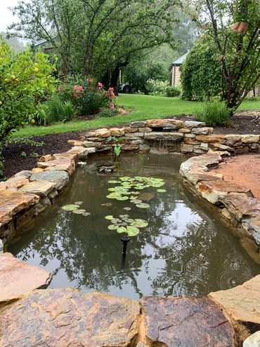 Adelaide Hills Sandstone water feature nestled into the surrounding landscape.