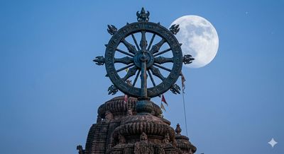 Ancient temple wheel with a full moon in the background.