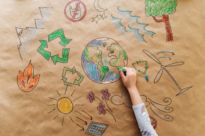 Child drawing Earth and environmental symbols.