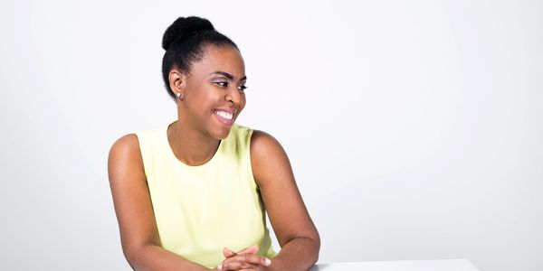 Sonya Harris speech language Pathologist looking to left and smiling with hands crossed