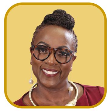 Smiling woman with glasses and braided hair against yellow background.