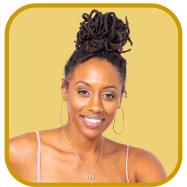 Smiling woman with dreadlocks styled in a bun, wearing hoop earrings and a delicate necklace.