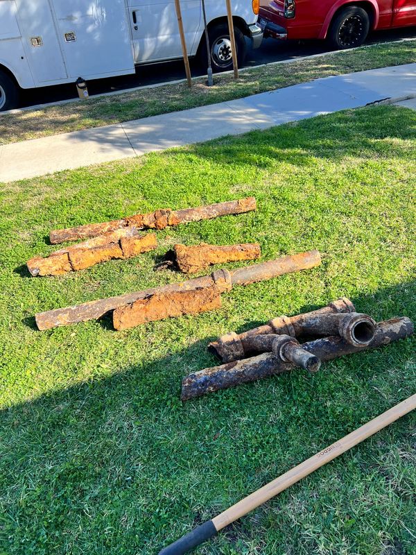 Old corroded cast iron pipes after repipe job under house and in yard