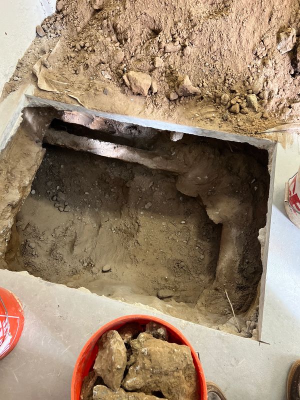Old cast iron pipe connected to clay main line