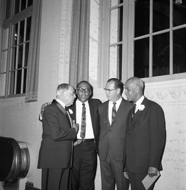 From left, H. Claude Hudson, Rev. H. H. Brookins, Kenny Hahn, and Roy Wilkins talking near the top o