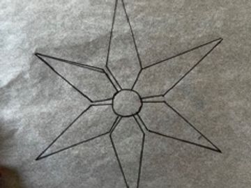 A six-pointed star drawn with black lines on gray paper.
