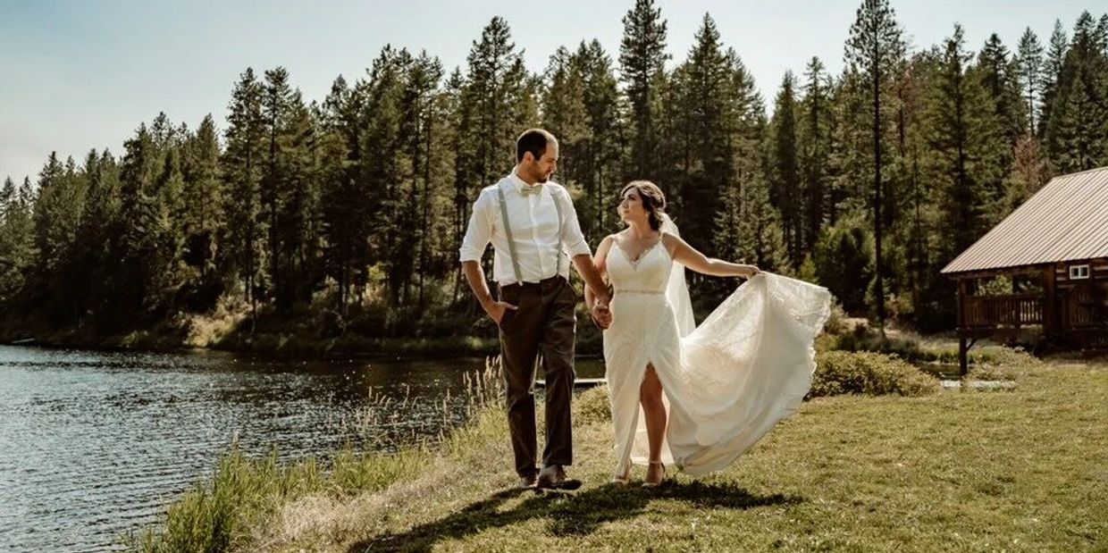 newly wedded couple taking a walk on the shores of horseshoe lake while wearing their wedding attire