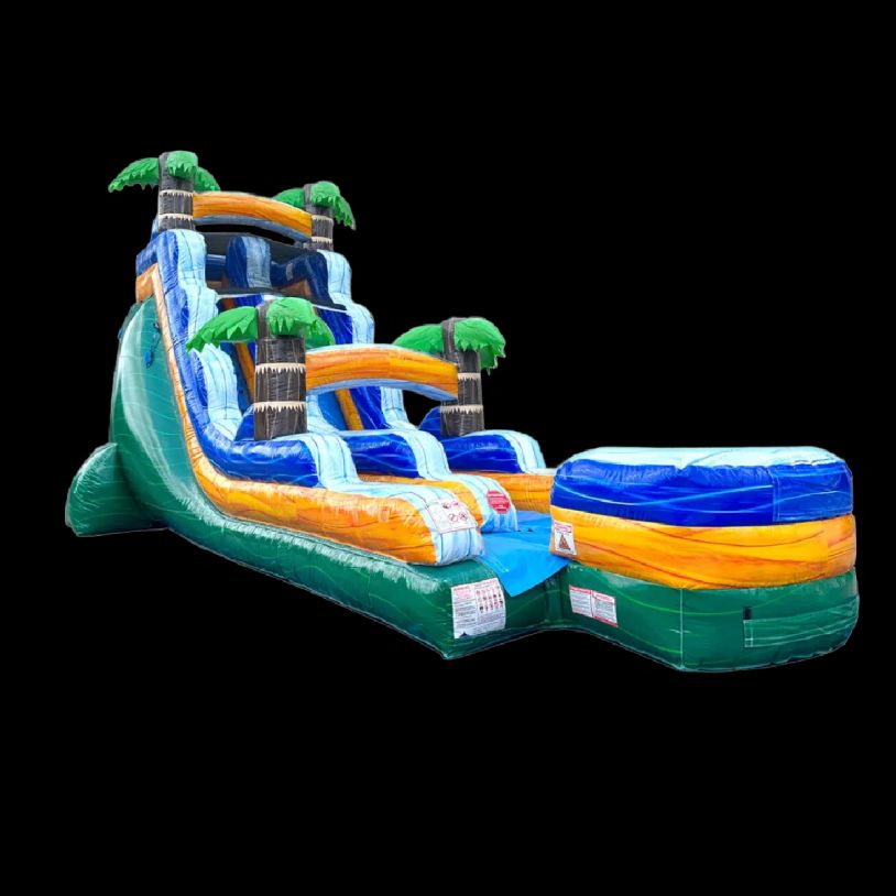 Colorful inflatable water slide with palm tree decorations.