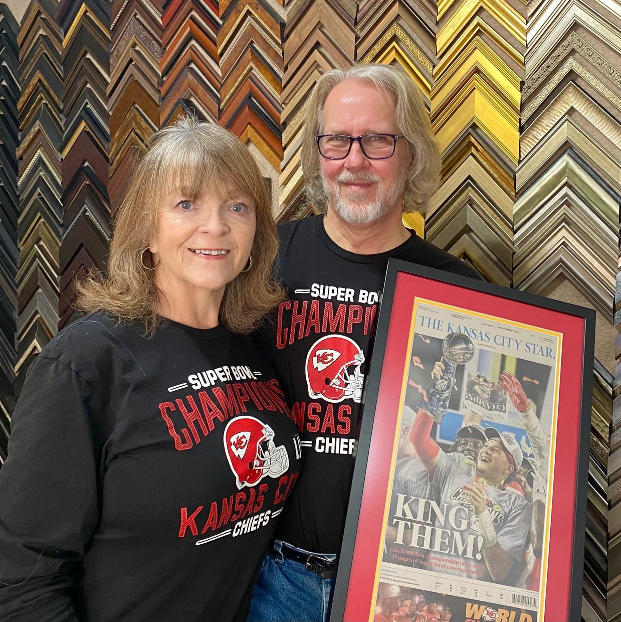 Vince and Mia holding the Mahoney Super Bowl Framed Newspaper
