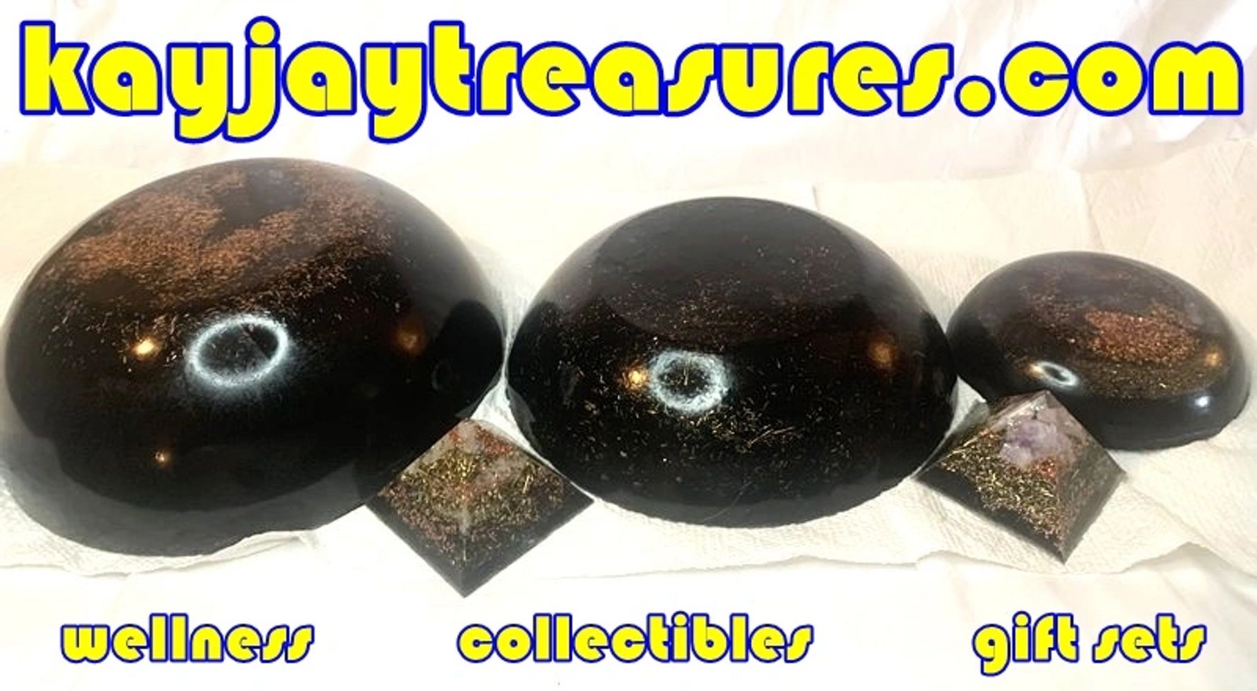 Shiny black domes and pyramids displayed with a website and category labels.