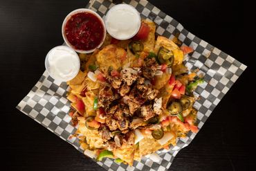 Our loaded grilled chicken nachos with salsa and sour cream.