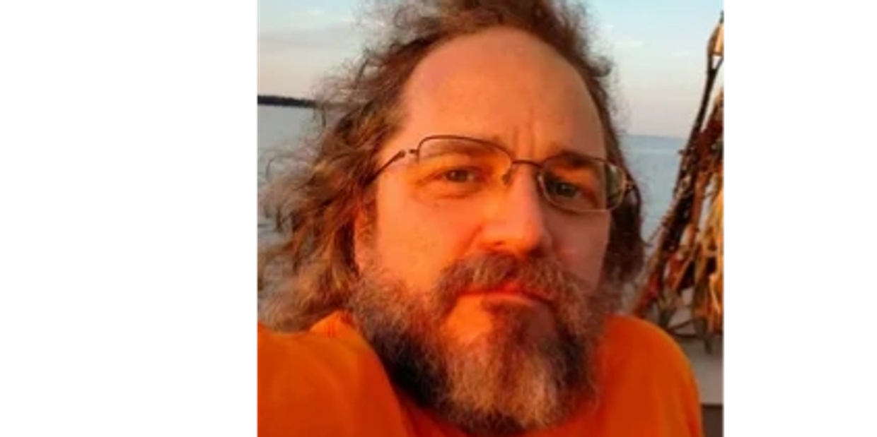 Closeup shot of a man in an orange tshirt