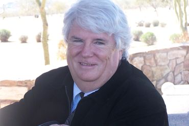 man wearing black jacket with bright background