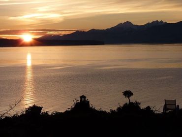 bushes and mountain with lake and sunset