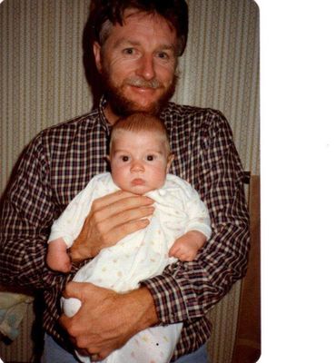 man holding baby in white