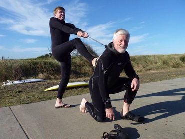 photo of son tightening man's shirt