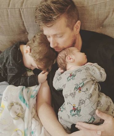 father sleeping with two children