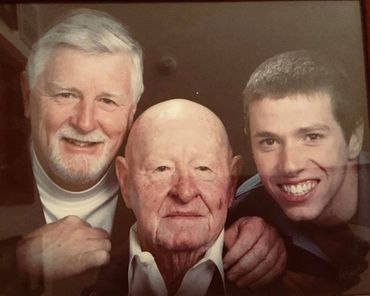 three guys taking a family photo