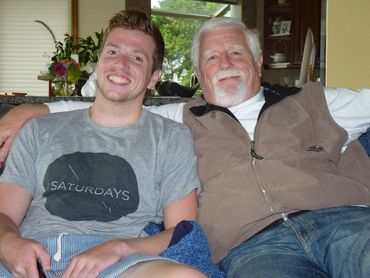 father and son relaxing on couch