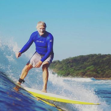 grandfather surfing on wave