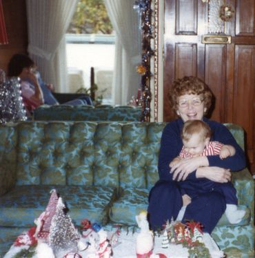 mother and baby sitting on couch