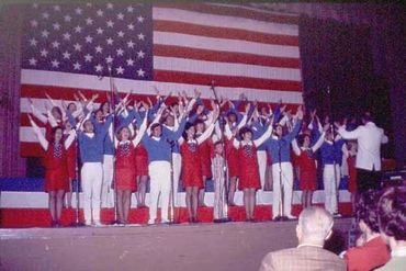 GLS performing and holding their arms up