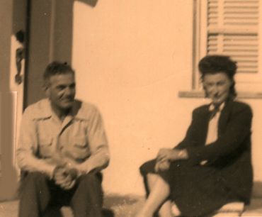 sepia-toned photo of man and woman seated