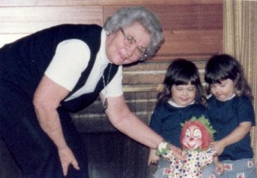 photo of two girls being gifted a doll