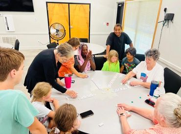 Our students are enjoying playing dominoes at the Mayflower Senior Citizens Center.