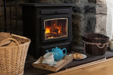Woodburner in the cosy lounge at Arallt Holiday Cottage, eco-friendly  holiday cottage North Wales