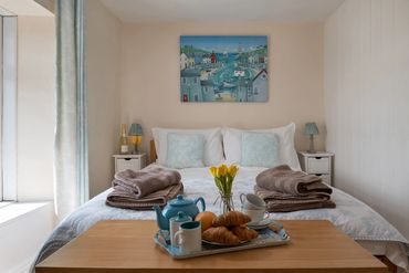 Master bedroom at Arallt Holiday Cottage on the Llyn Peninsula, North Wales.Showing bed made up for