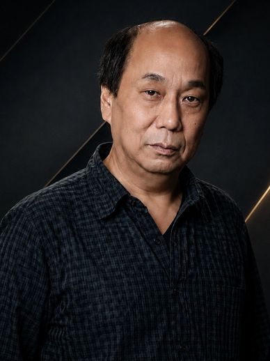 中年男子,穿着深色格子衬衫。