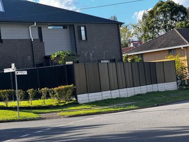 Residential houses with a street sign at a sunny intersection.
