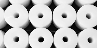 Stack of white cylindrical objects with central holes.