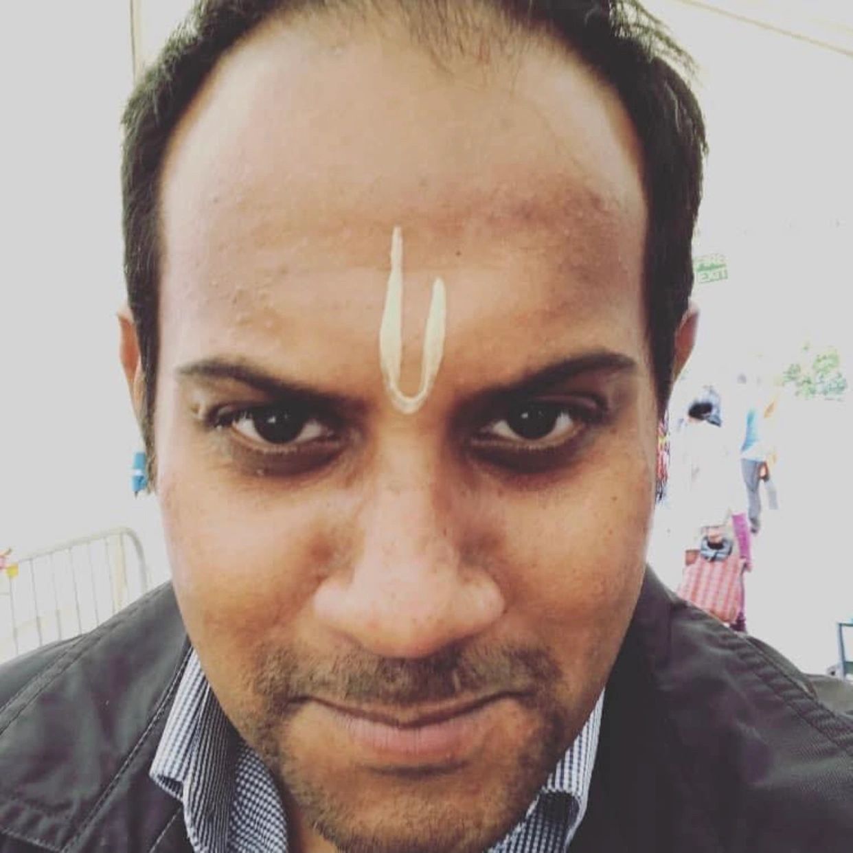 Close-up of a man with religious forehead marking.