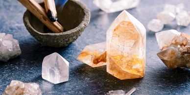 palo santo burning surrounded by crystals