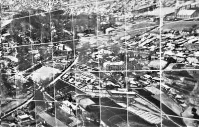 Aerial view of a town with buildings and roads.