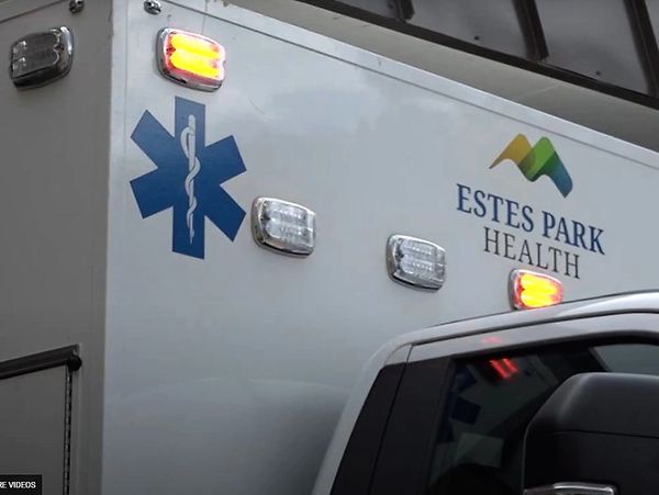 Emergency medical vehicle from Estes Park Health with flashing lights.